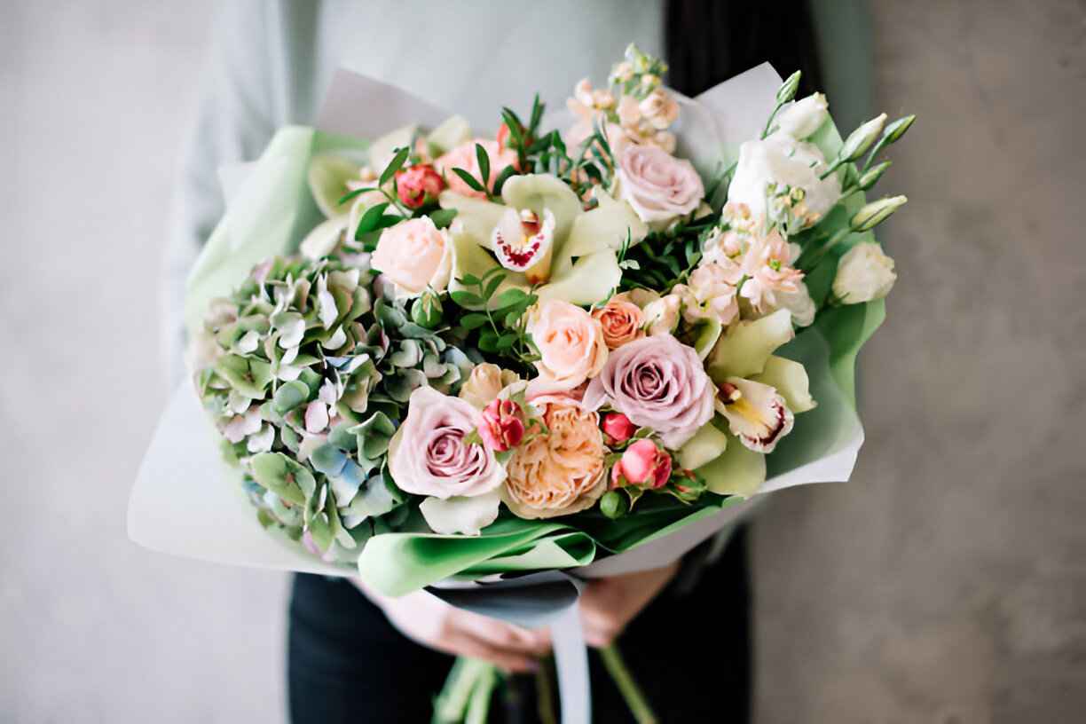 A vibrant flower bouquet with a mix of roses and greenery