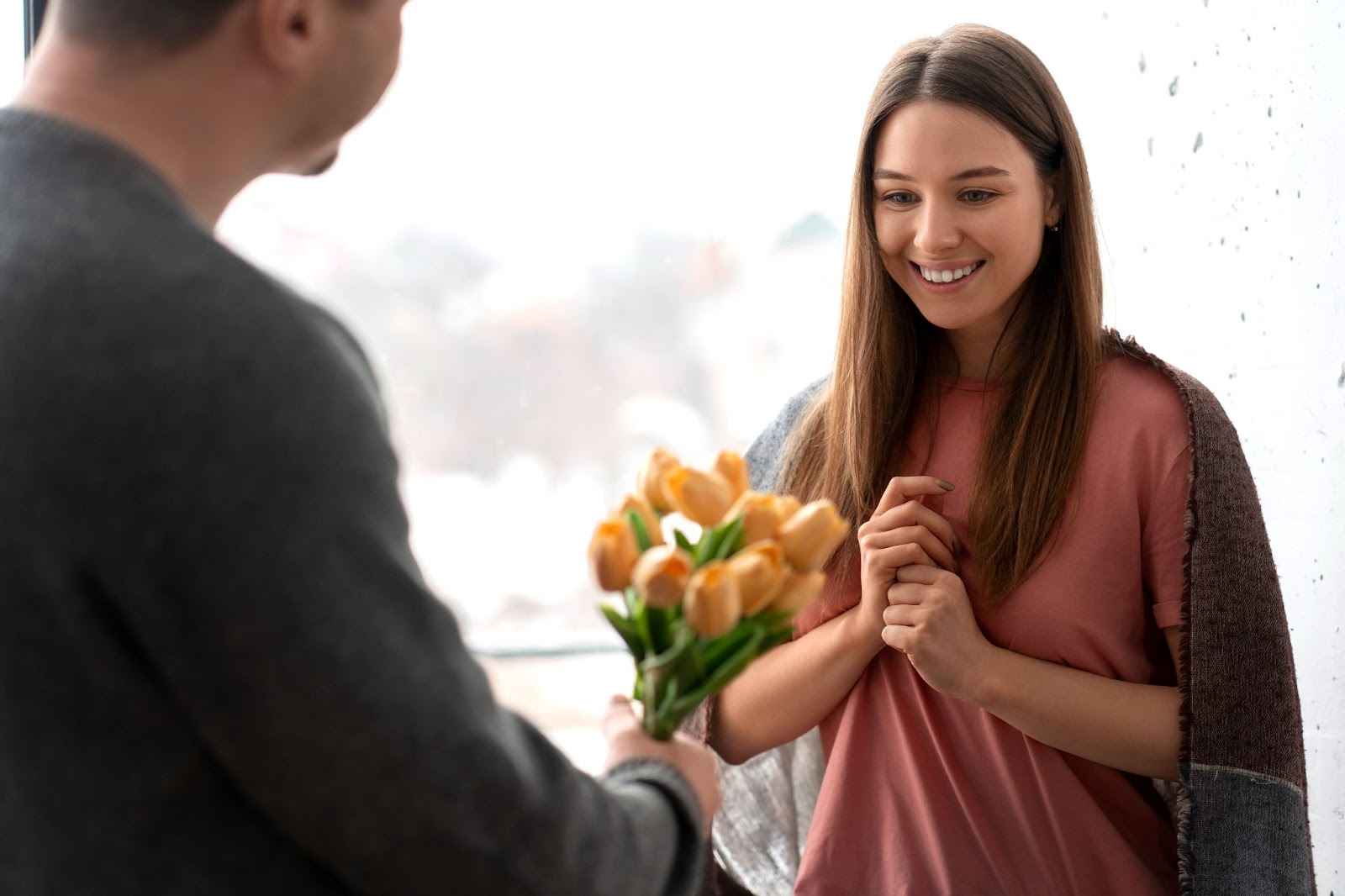 man giving rose bouquet to girlfriend