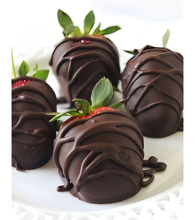 Six strawberries dipped in dark chocolate with drizzle