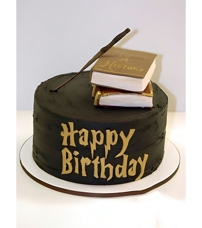 كعكة على شكل عصا سحرية وكتب تعاويذ