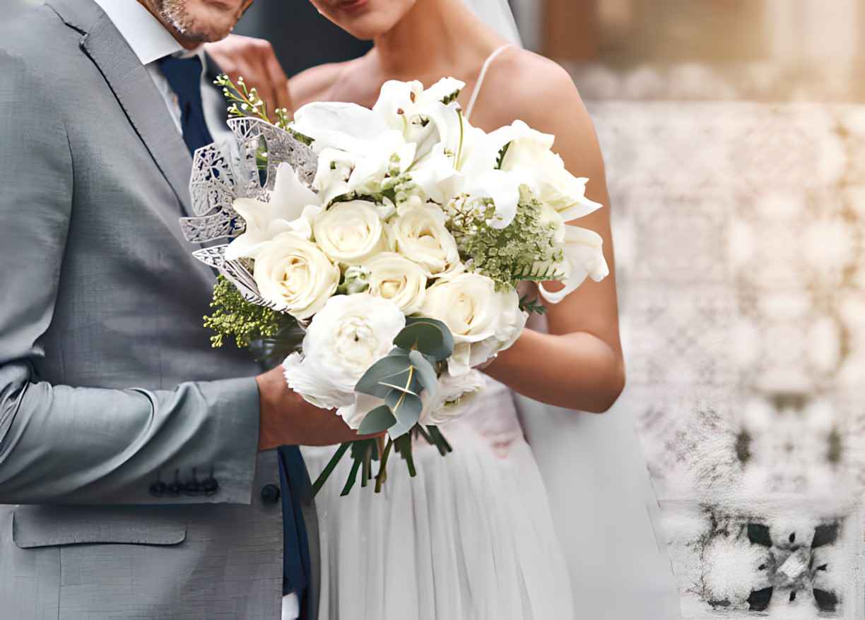 married couple holding white arrangement